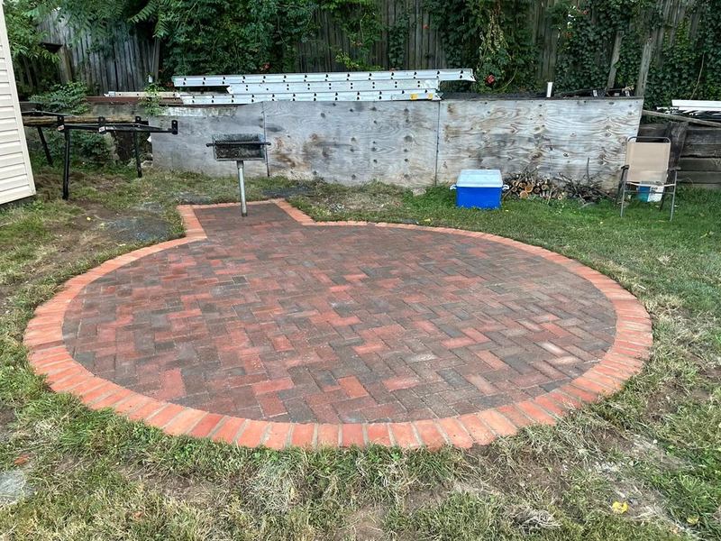 Circular brick paver patio in a Baltimore backyard