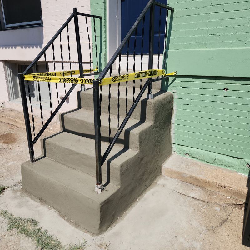 Concrete steps rebuilt with black metal railing in Baltimore
