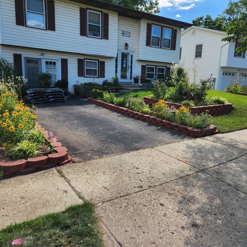 Brick-edged flower beds along a driveway