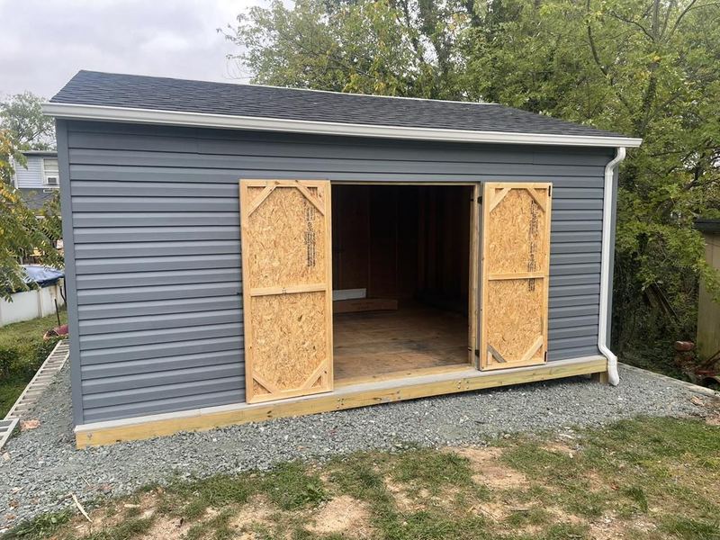 Custom shed with siding and shingled roof