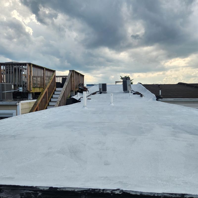 Reflective silver coating applied to a flat roof