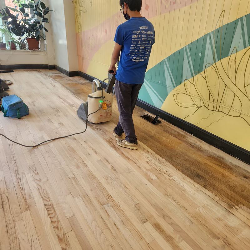Hardwood floors being sanded and refinished