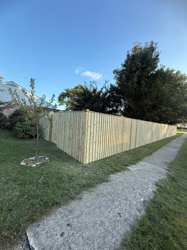 Wood privacy fence along a sidewalk